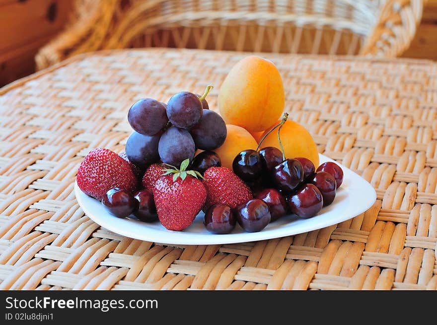 Plate with fruit and berries on the table