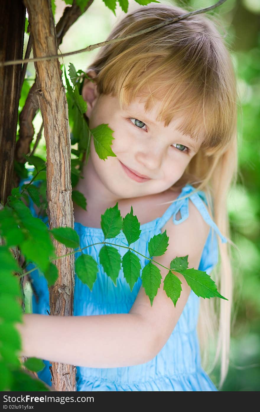 Little Girl In Blue Dress In The Park