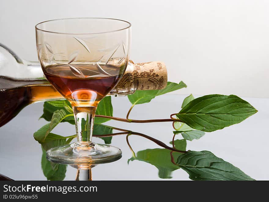 Glass of red wine near wine bottle