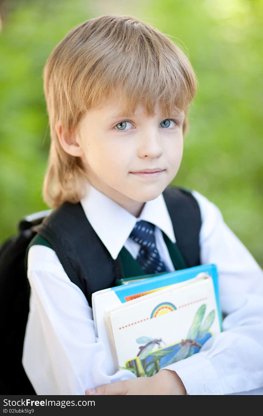 Boy with books outdoor