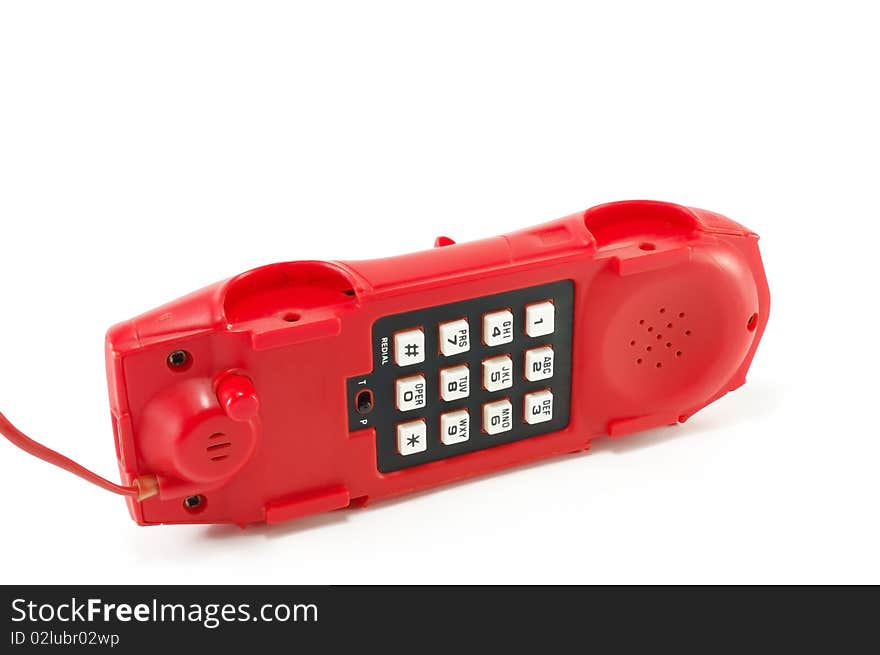 The old red telephone isolated on a white background. The old red telephone isolated on a white background