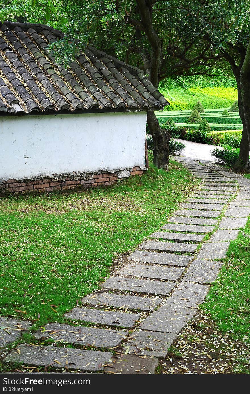 Stone path behind an old house.