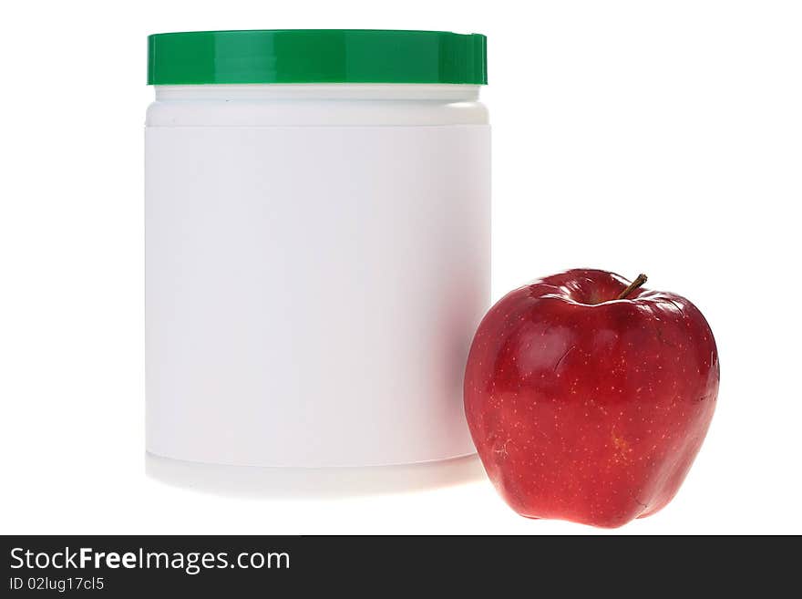 The container with power additives and a red apple.