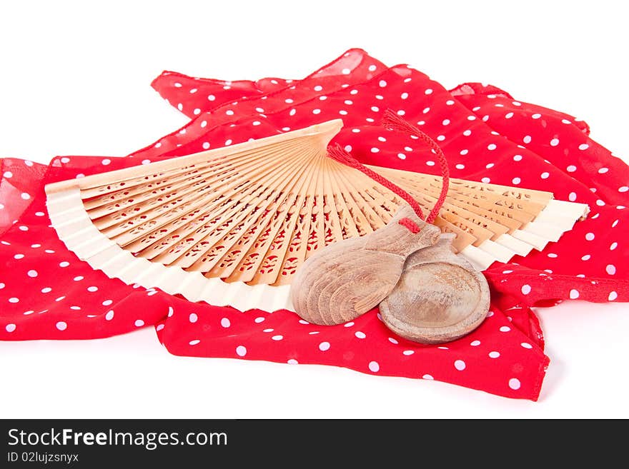 A spanish flamenco fan with wooden  castanets  isolated over white. A spanish flamenco fan with wooden  castanets  isolated over white