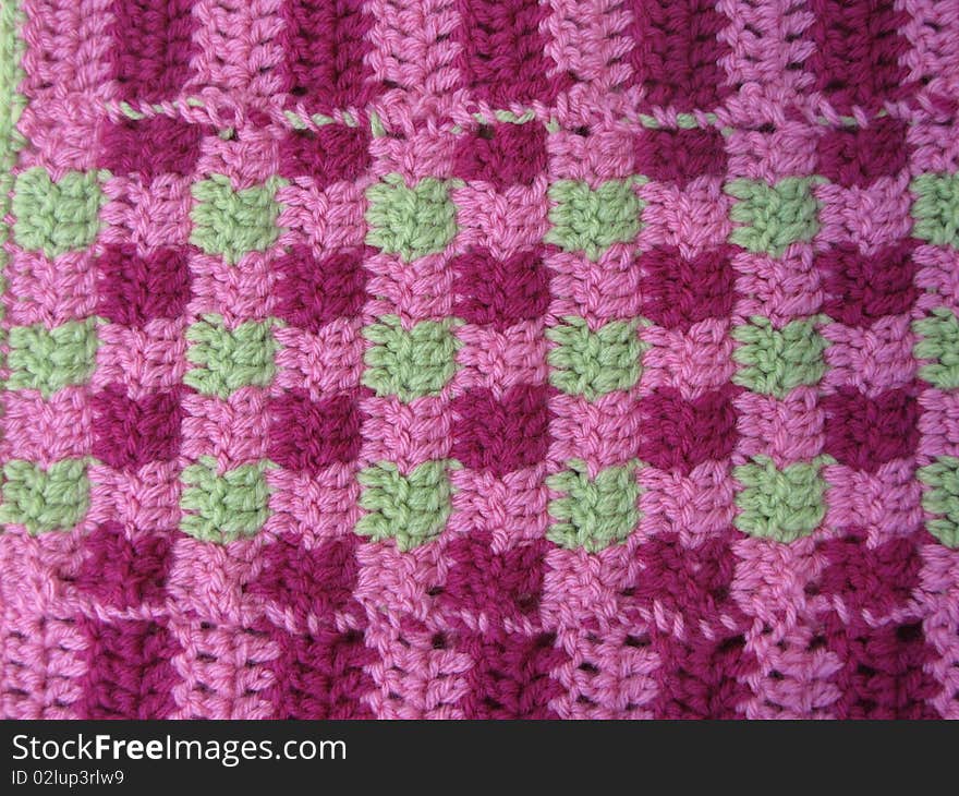 Pink and purple yarn blanket used as a blanket. Pink and purple yarn blanket used as a blanket