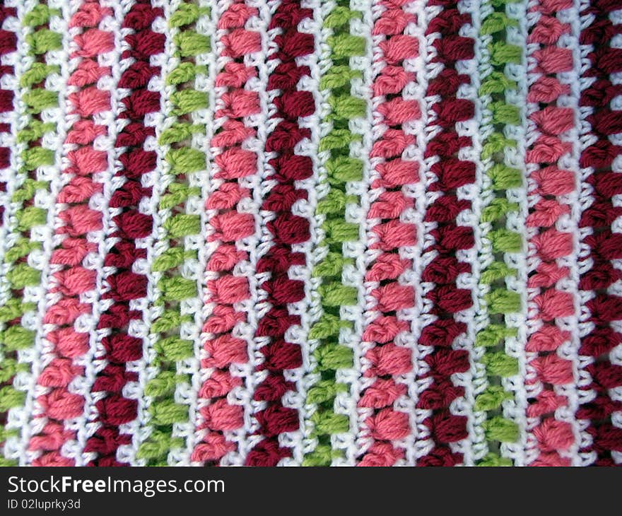 Colorful crocheted yarn blanket used as a background