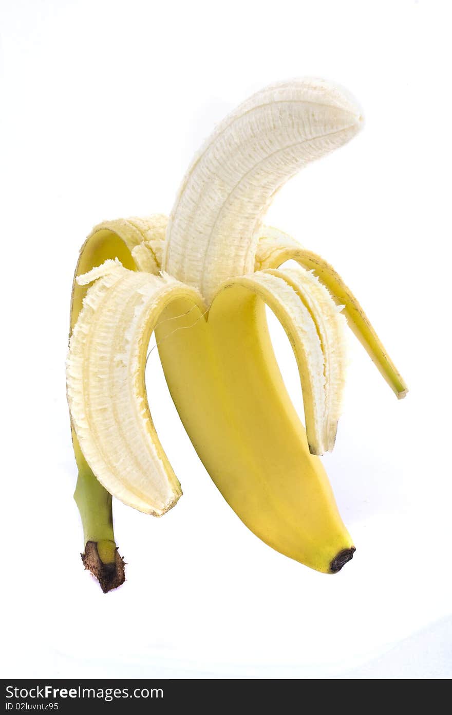 Half peeled banana on a white background. Half peeled banana on a white background