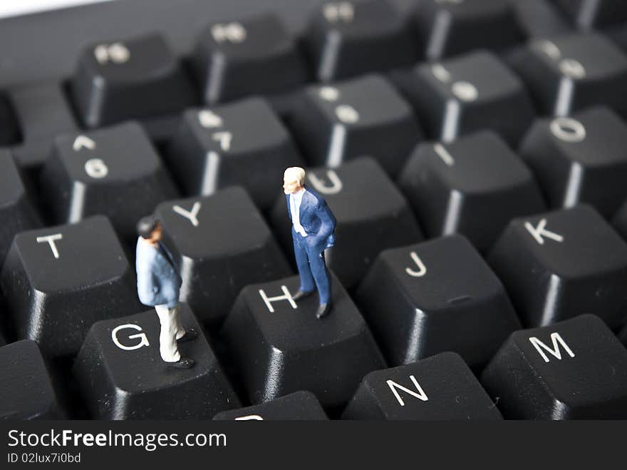 Miniature people on keyboard buttons. Miniature people on keyboard buttons