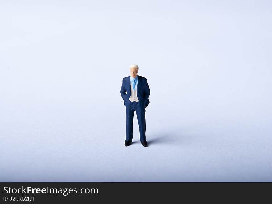 One miniature man standing alone