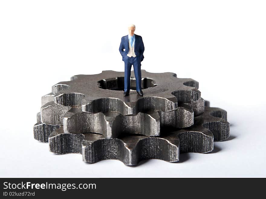 Miniature man on gears standing