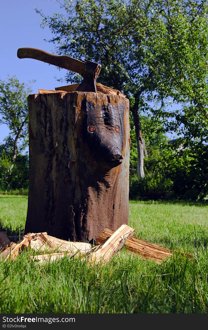 The old time wooden block with a bench axe. The old time wooden block with a bench axe