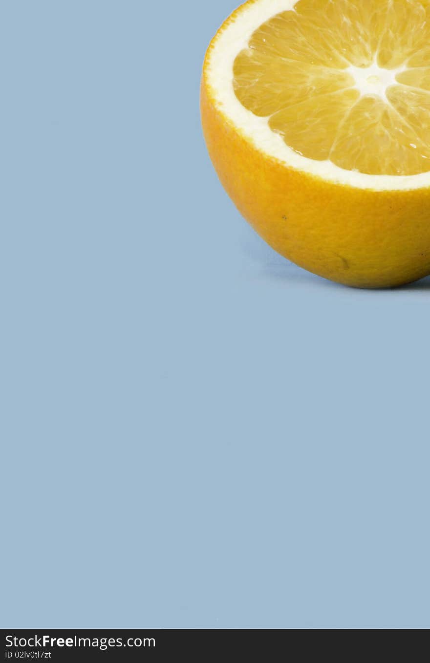 Half an orange isolated over a blue background