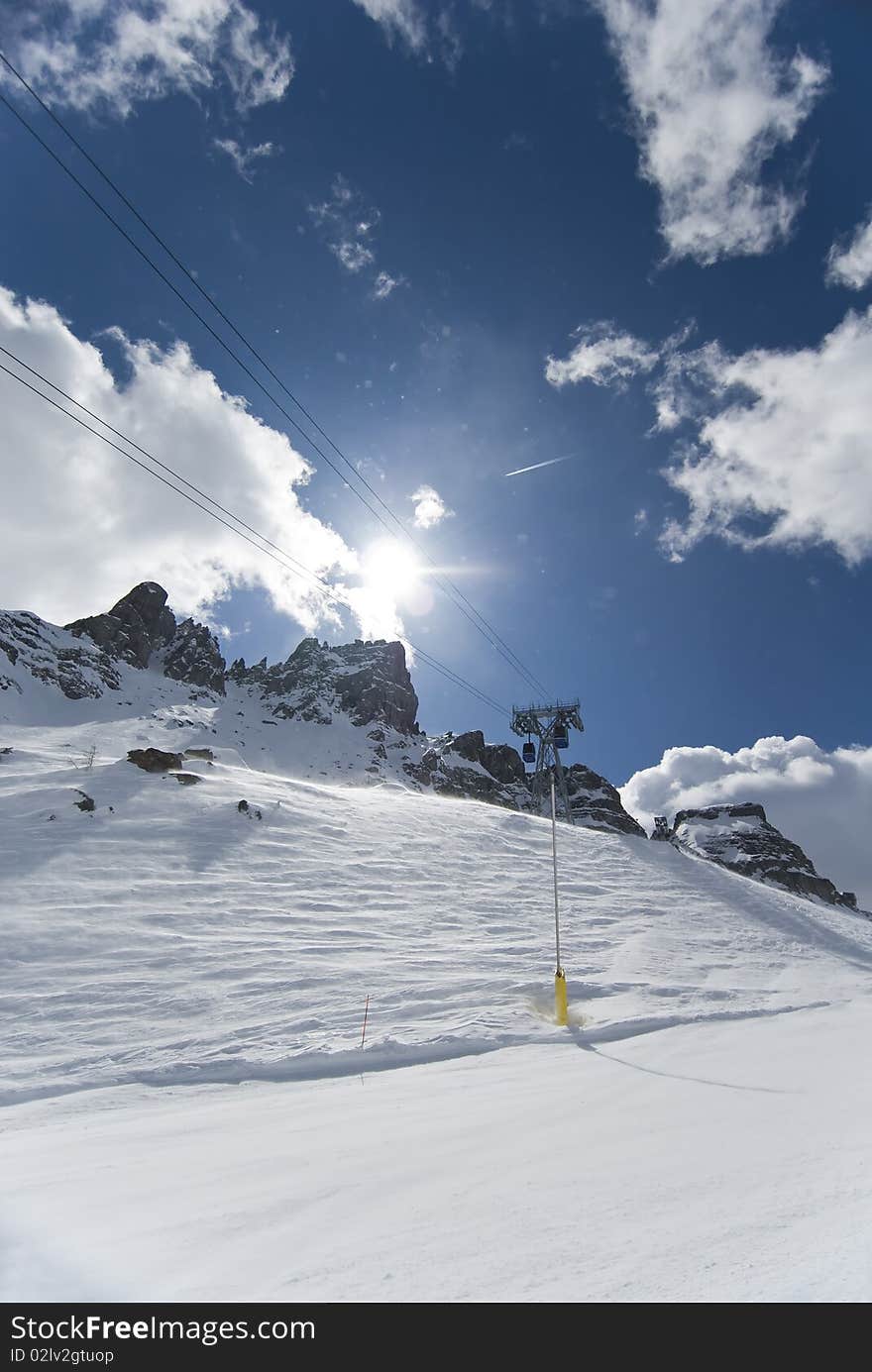 Cable car along a  skiing slope.