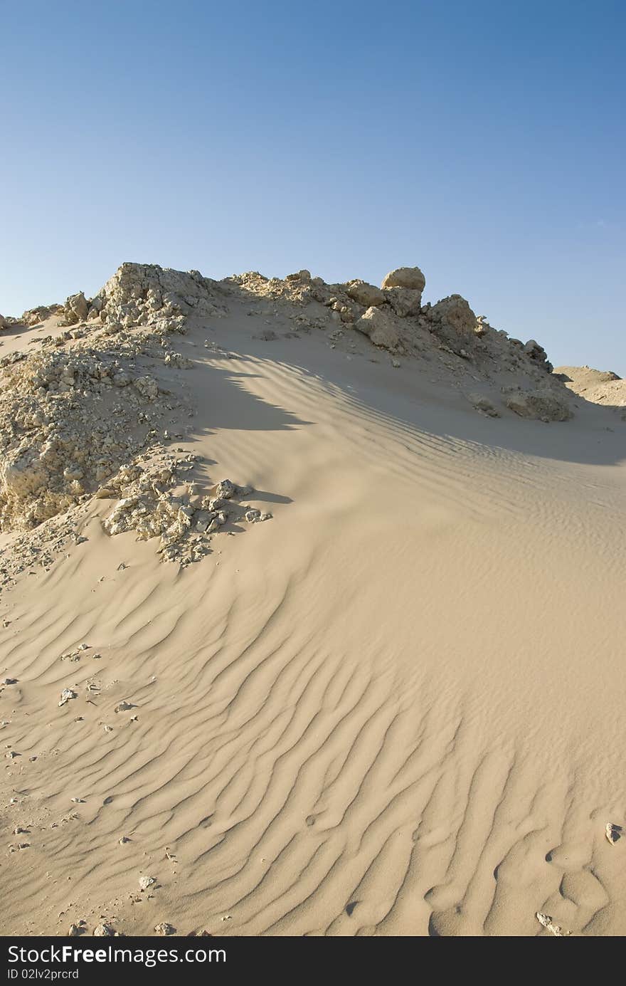 Small sand dune with natural ripples. Ras Mohamed National Park, South Sinai, Red Sea, Egypt. Small sand dune with natural ripples. Ras Mohamed National Park, South Sinai, Red Sea, Egypt.