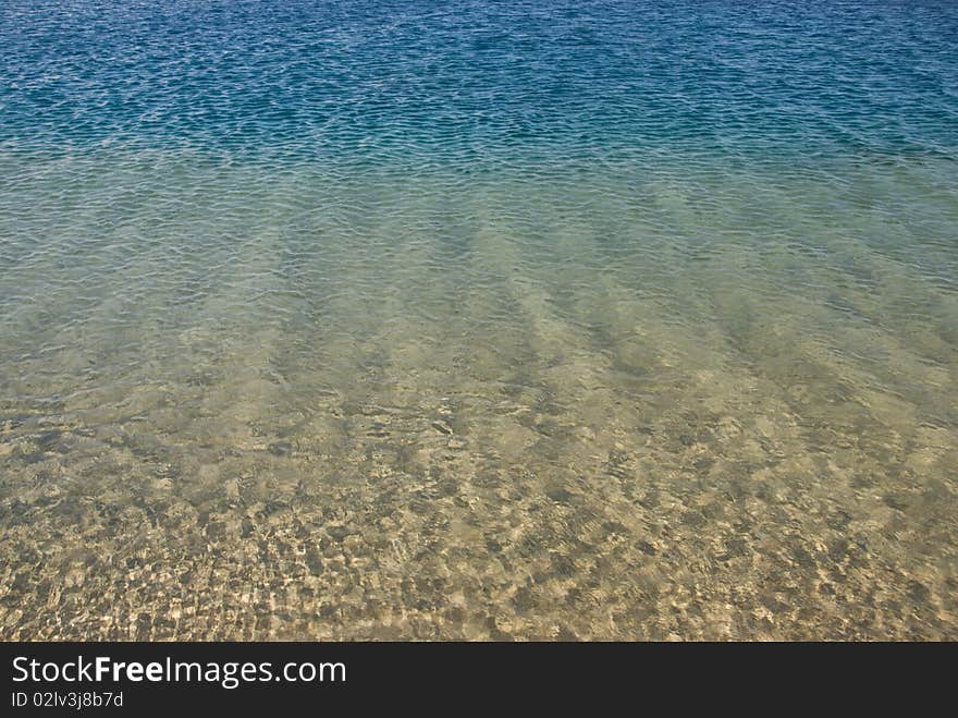 Gradated colors of the sea in shallow water with the ripples reflected on the sand below. Ras Mohamed National Park, South Sinai, Red Sea, Egypt. Gradated colors of the sea in shallow water with the ripples reflected on the sand below. Ras Mohamed National Park, South Sinai, Red Sea, Egypt.