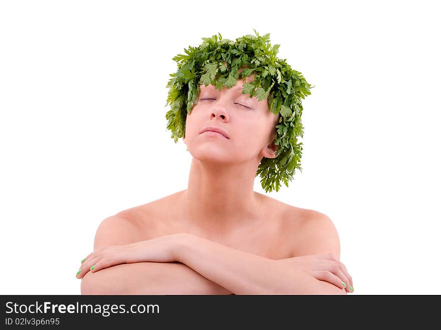 Young woman with green leafy hair made from parsley is relaxing. Studio shot on a white background. Young woman with green leafy hair made from parsley is relaxing. Studio shot on a white background.