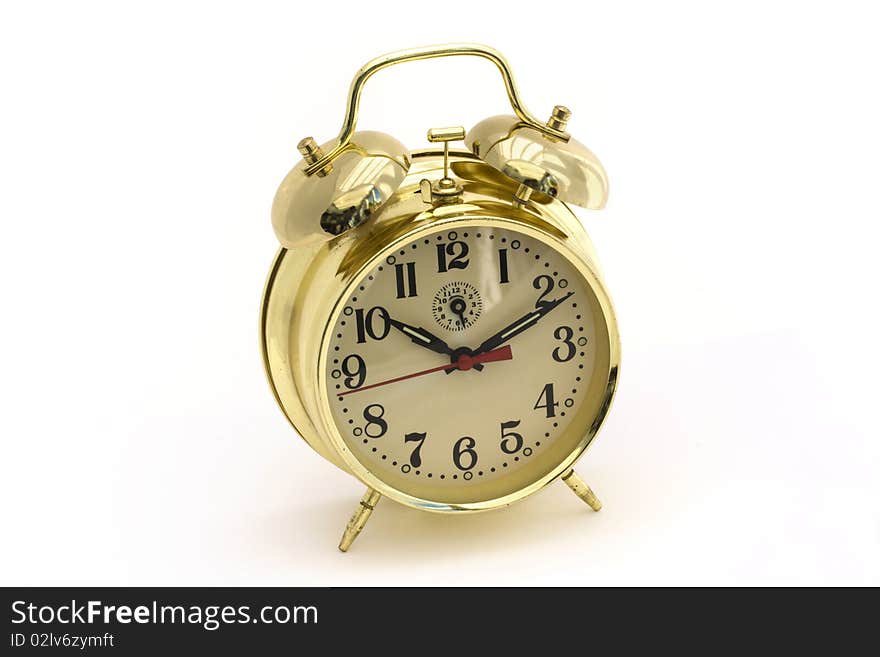 Gold alarm clock on a white background. Gold alarm clock on a white background