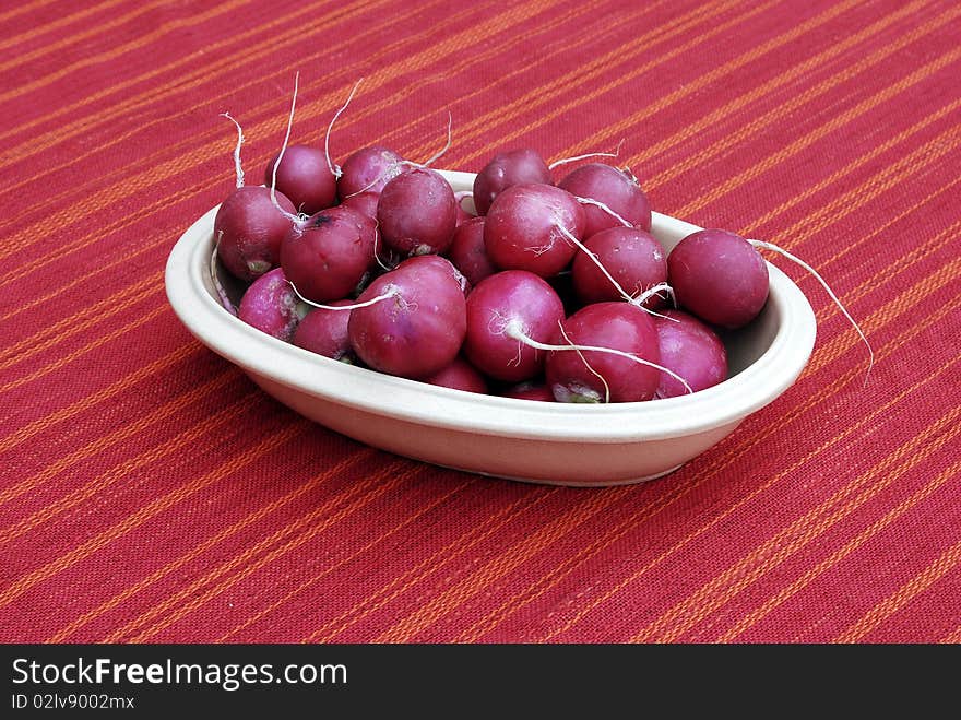 Bowl of radishes on a kitchen table