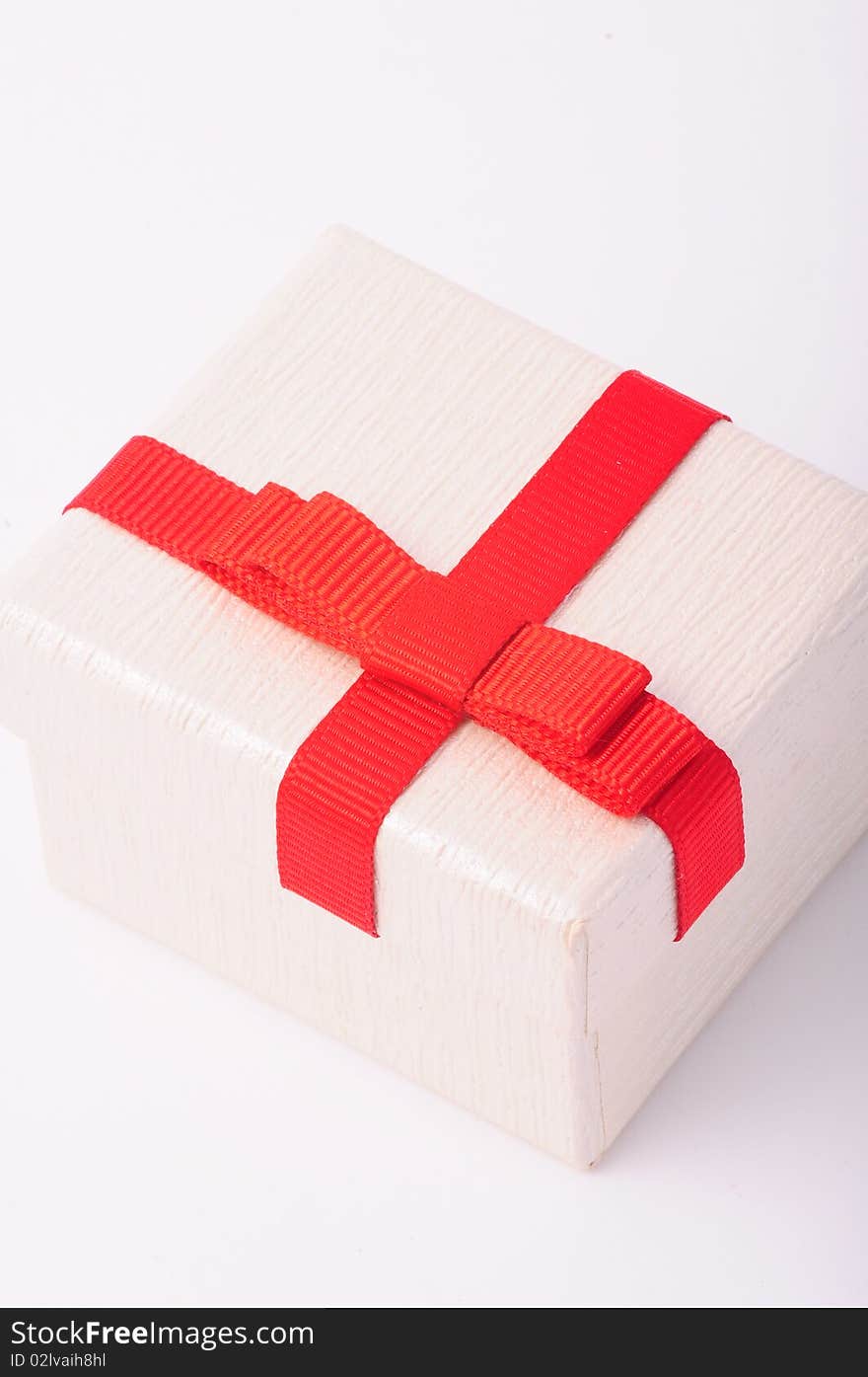 A white gift box with red ribbon