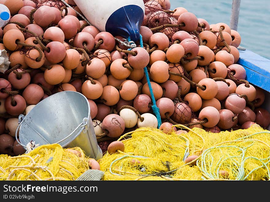 Fishing Tackle: Net, Bucket, Buoy On The Boat Desk