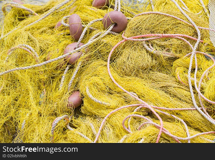 Tangled nylon yellow fishing tackle close-up: net, float, cord. Tangled nylon yellow fishing tackle close-up: net, float, cord