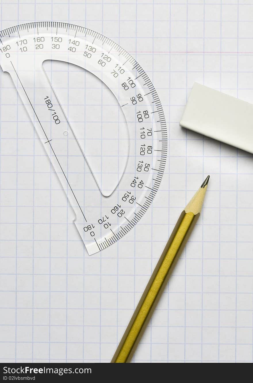 A pencil, an eraser and a ruler on the exercise book