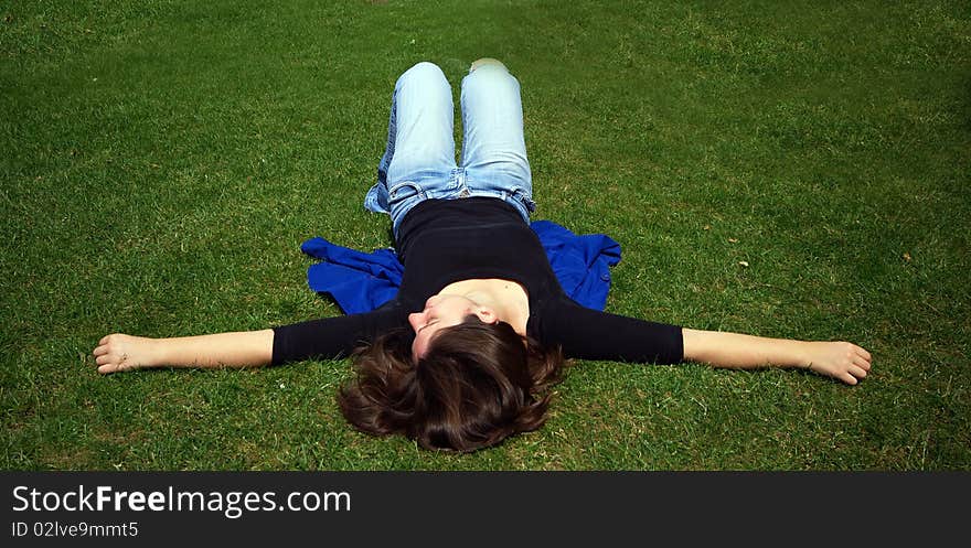 A woman having a relaxing sleep in a field