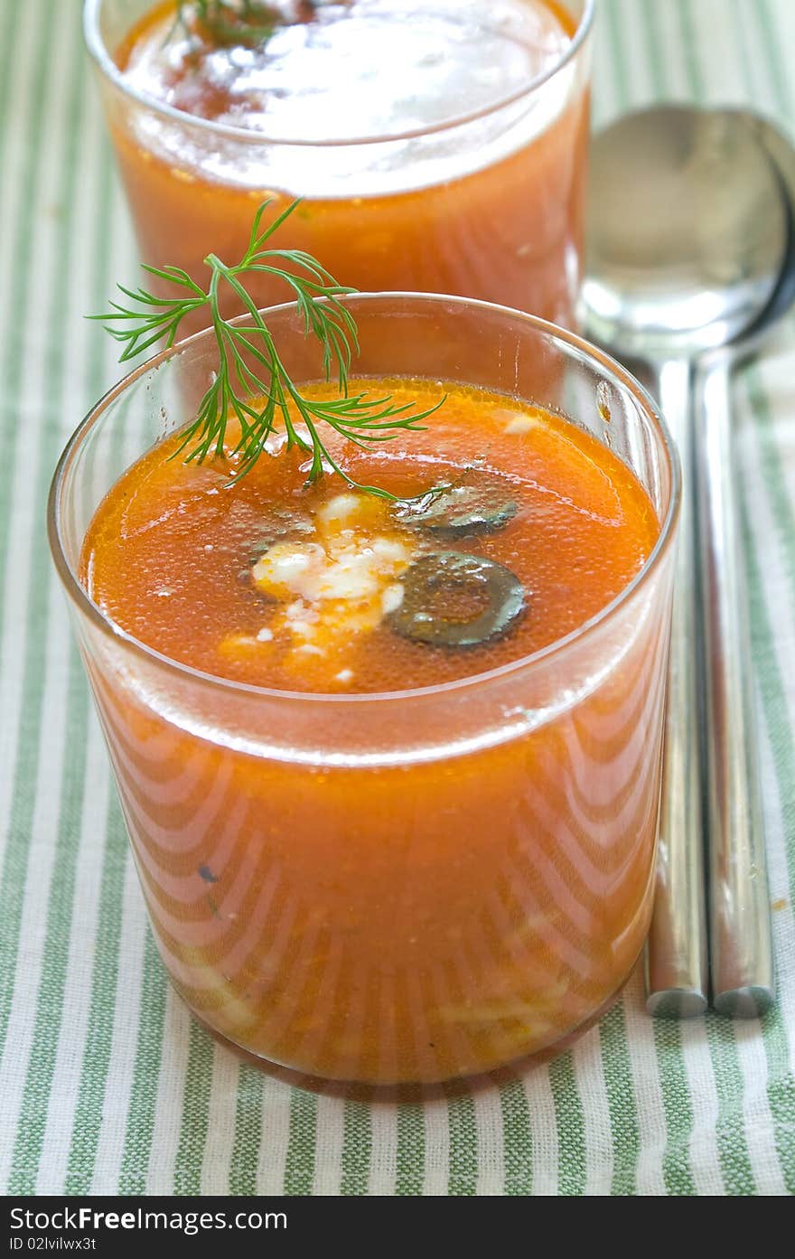 Glases of vegetable soup on table