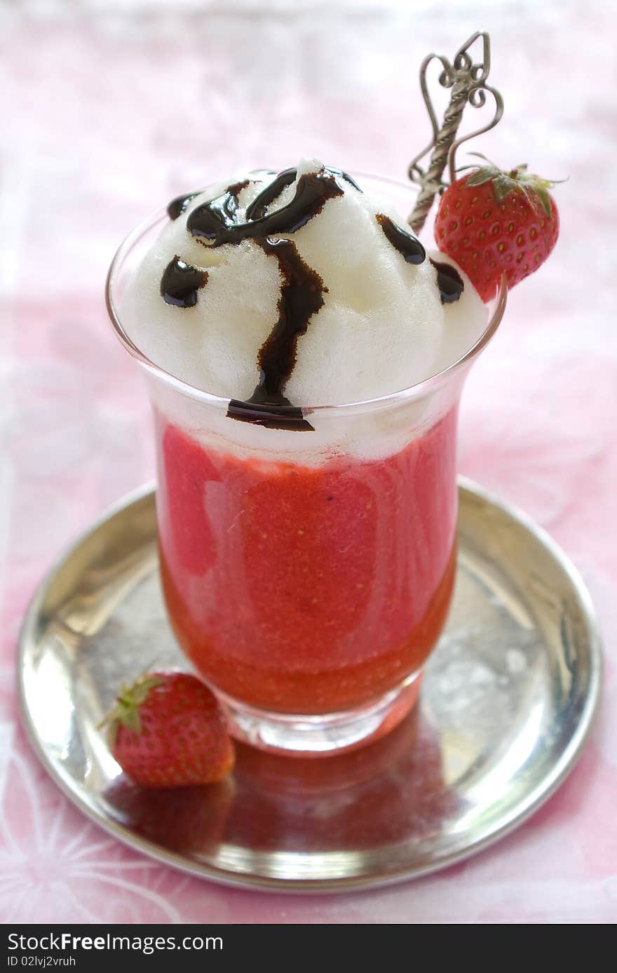 Strawberry dessert decorated with fresh strawberry and syrup