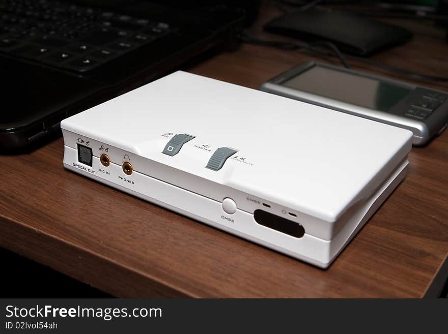 External white sound card on a desk. External white sound card on a desk.