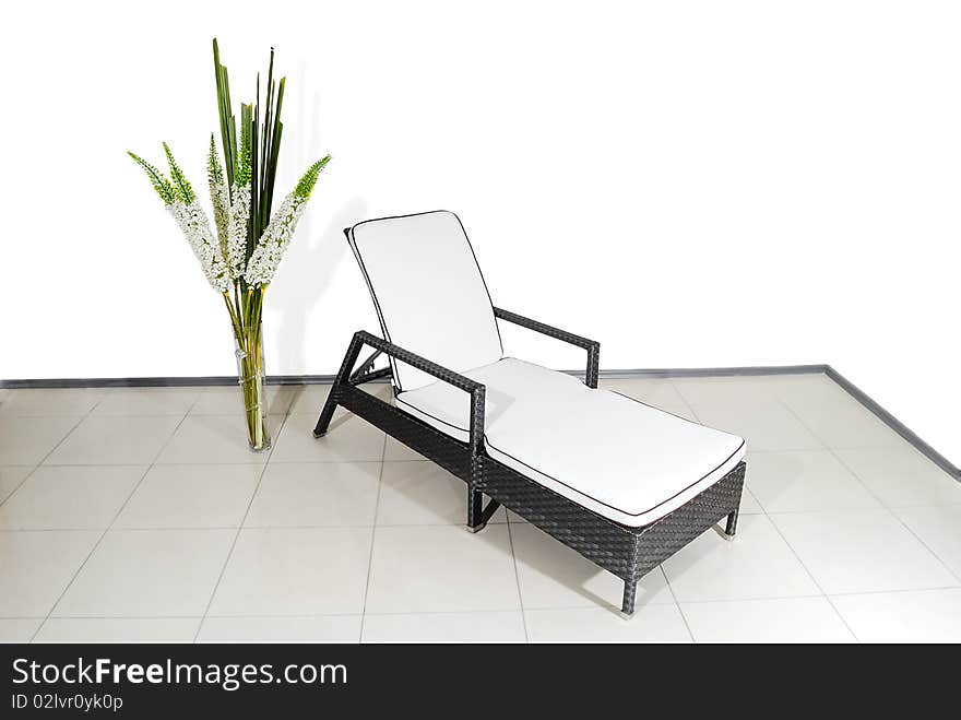 White and grey Chaise-lounge from rod over white wall. White and grey Chaise-lounge from rod over white wall