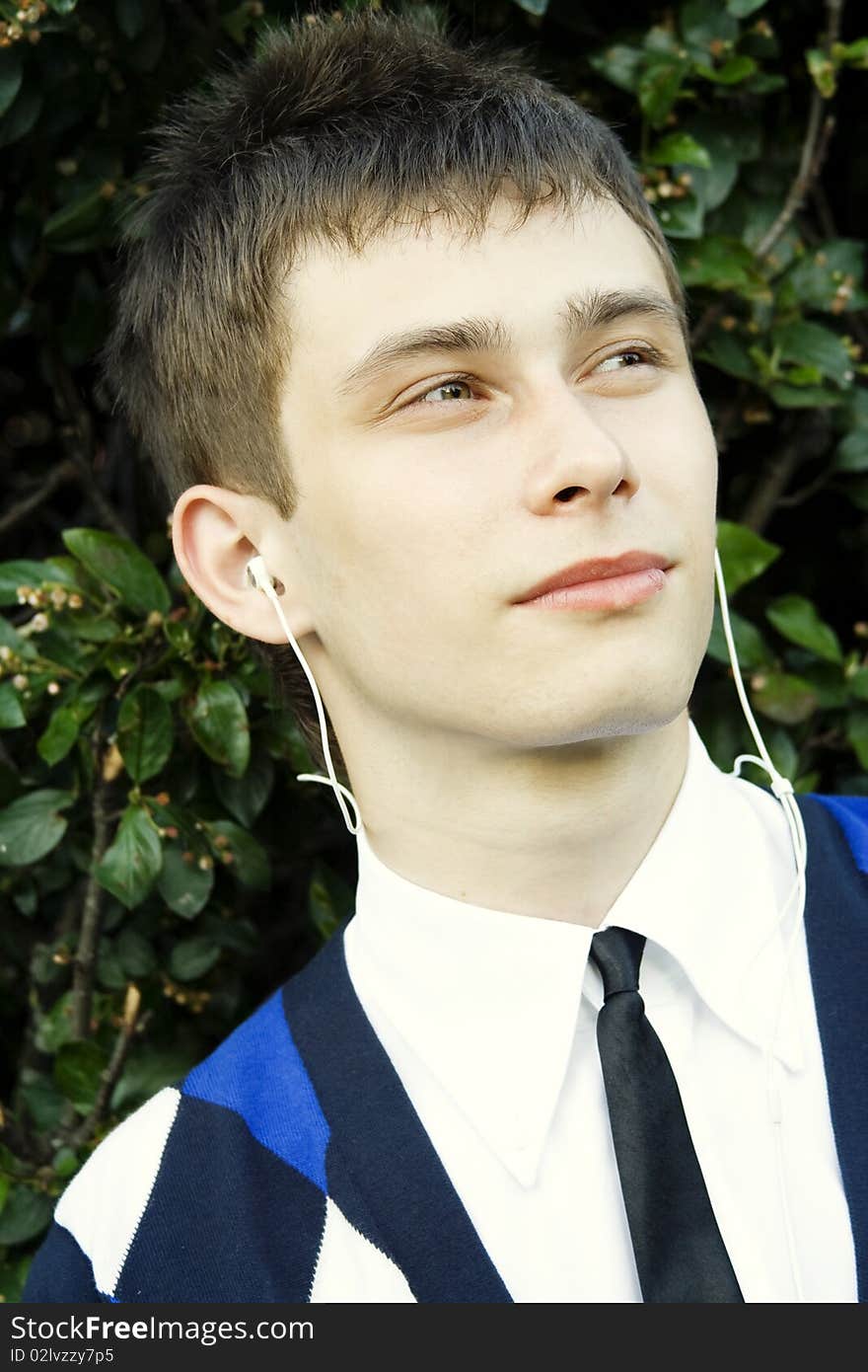 Teenager in a park listening to music