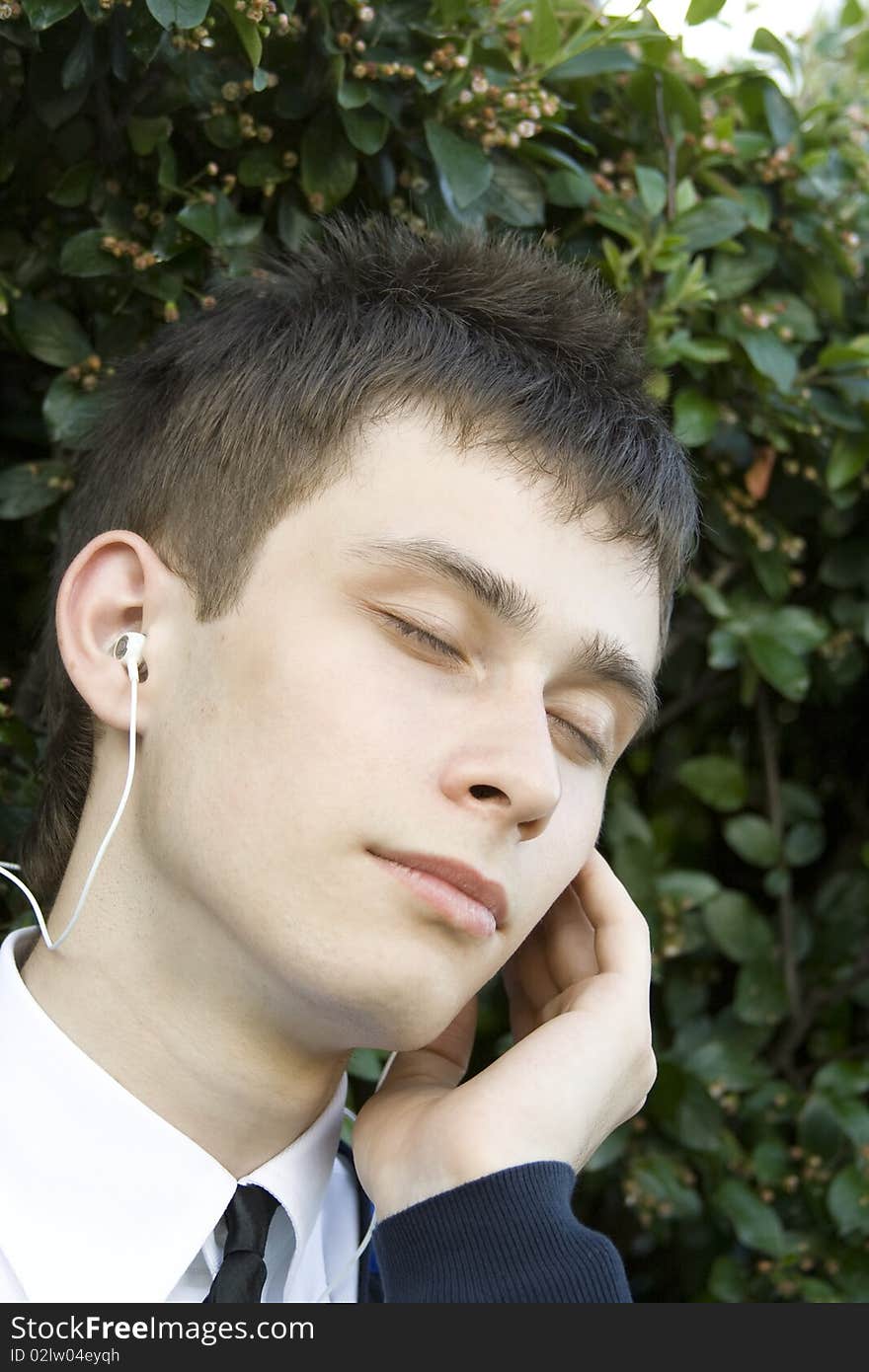 Teenager in a park listening to music