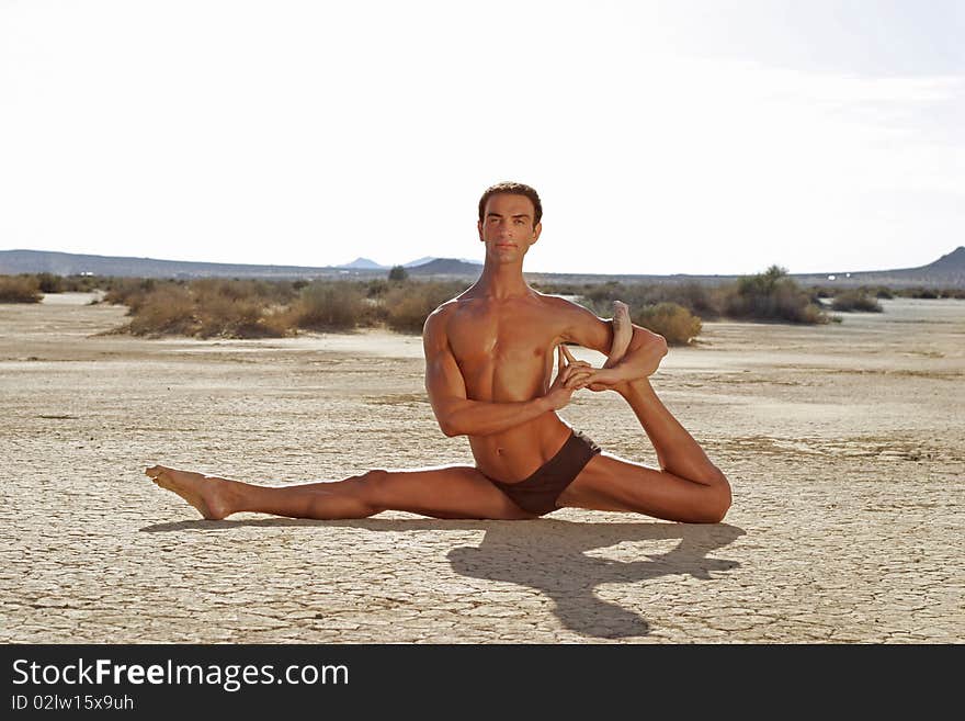 Young man performing Yoga pose in the desert. Young man performing Yoga pose in the desert