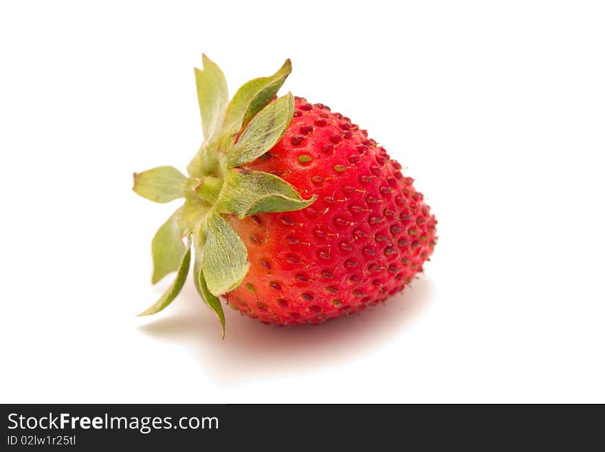 A watery ripe strawberry isolated on a white background