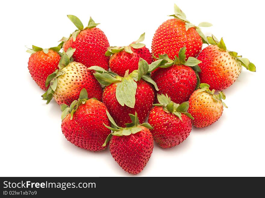 Strawberries in a heart shape isolated on a white background. Strawberries in a heart shape isolated on a white background