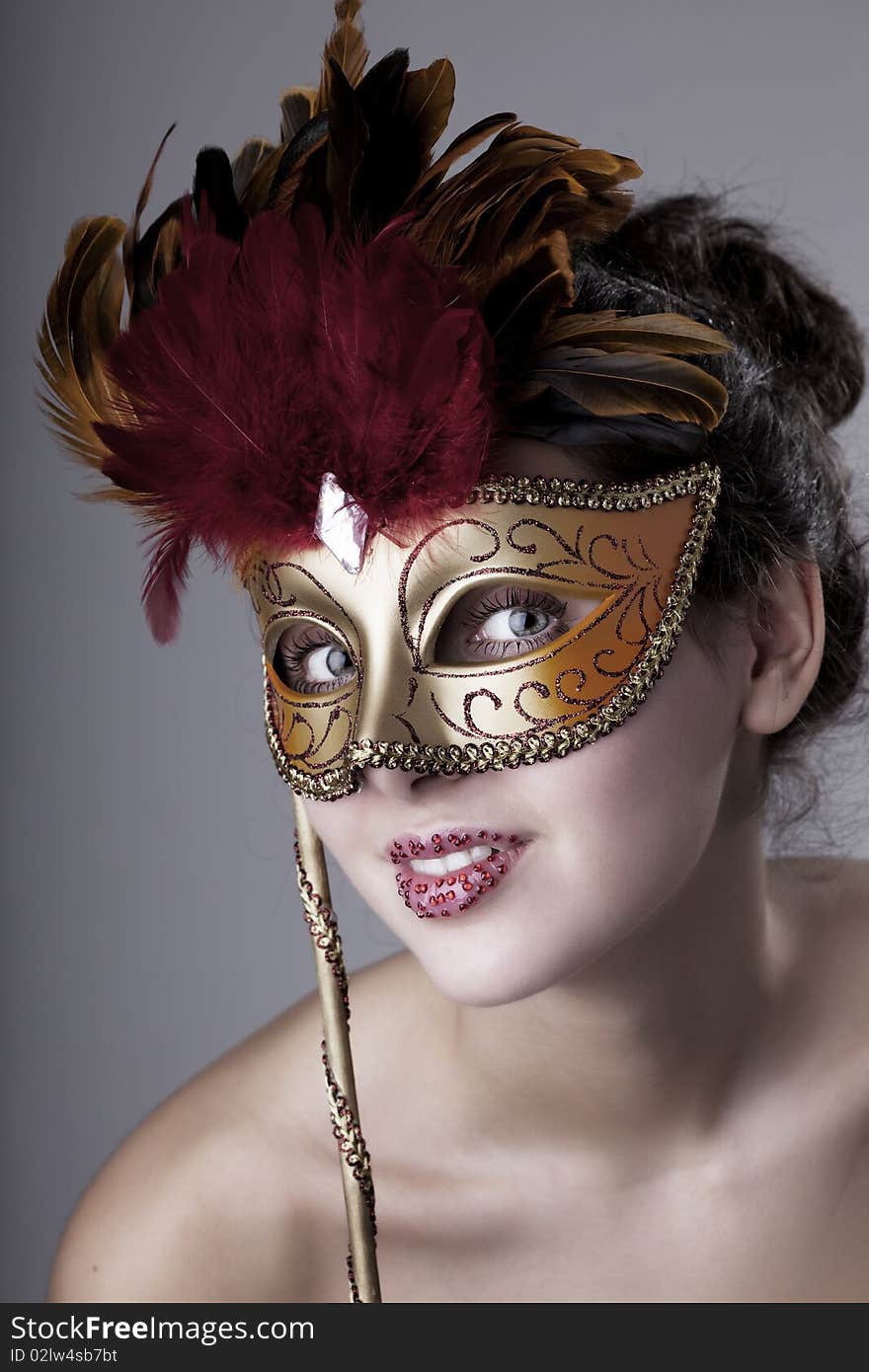 Beautiful girl with a carnival mask