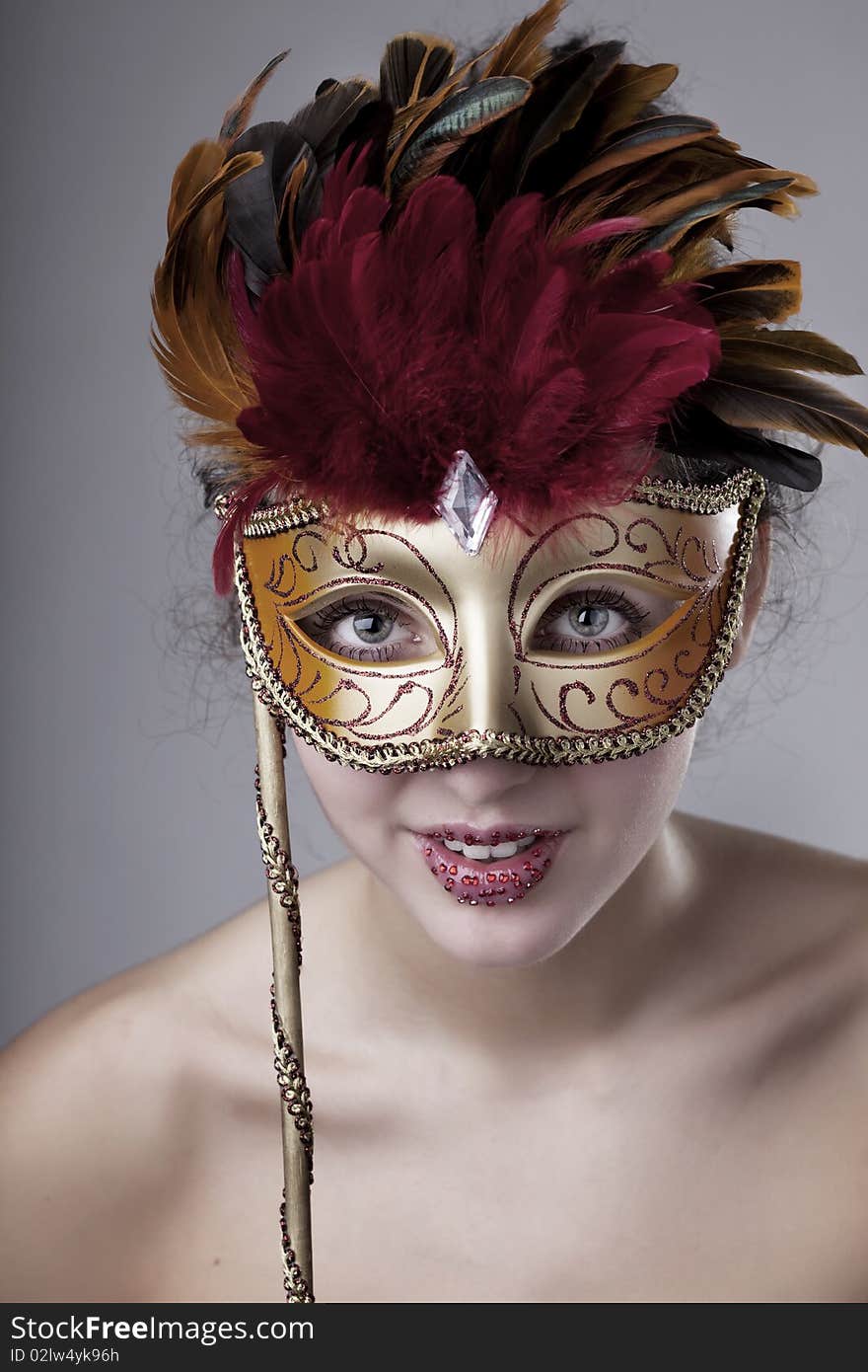 Beautiful girl with a carnival mask