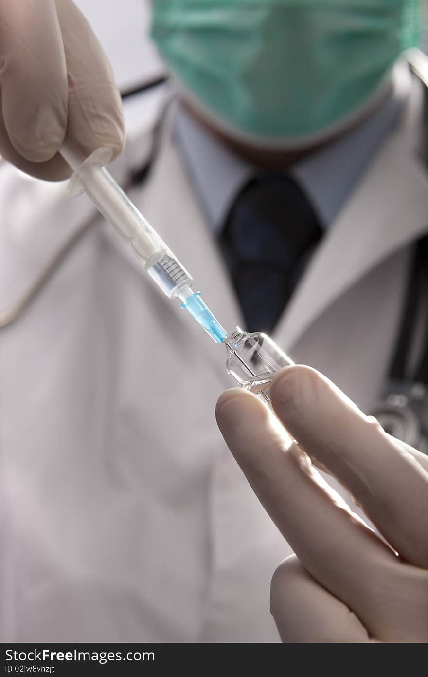 Professional doctor with medical syringe in hands, getting ready for injection