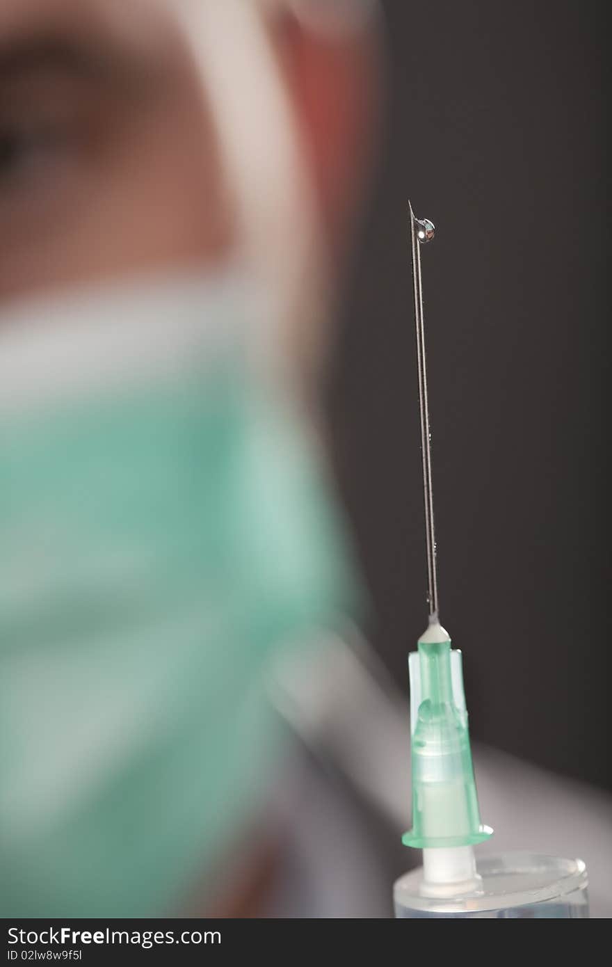 Professional doctor with medical syringe in hands, getting ready for injection