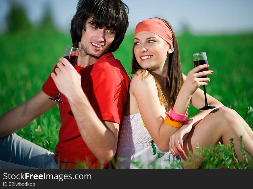 Beautiful girl in kerchief and boy with wineglasses