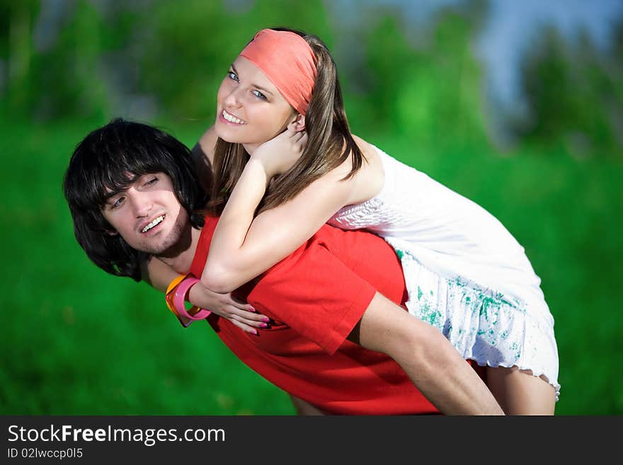 Long-haired girl in kerchief and boy on green background. Long-haired girl in kerchief and boy on green background