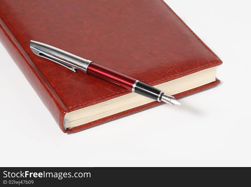 Business-ogranayzer and pen.Leather cover. Diary businessman. Stylish pen.