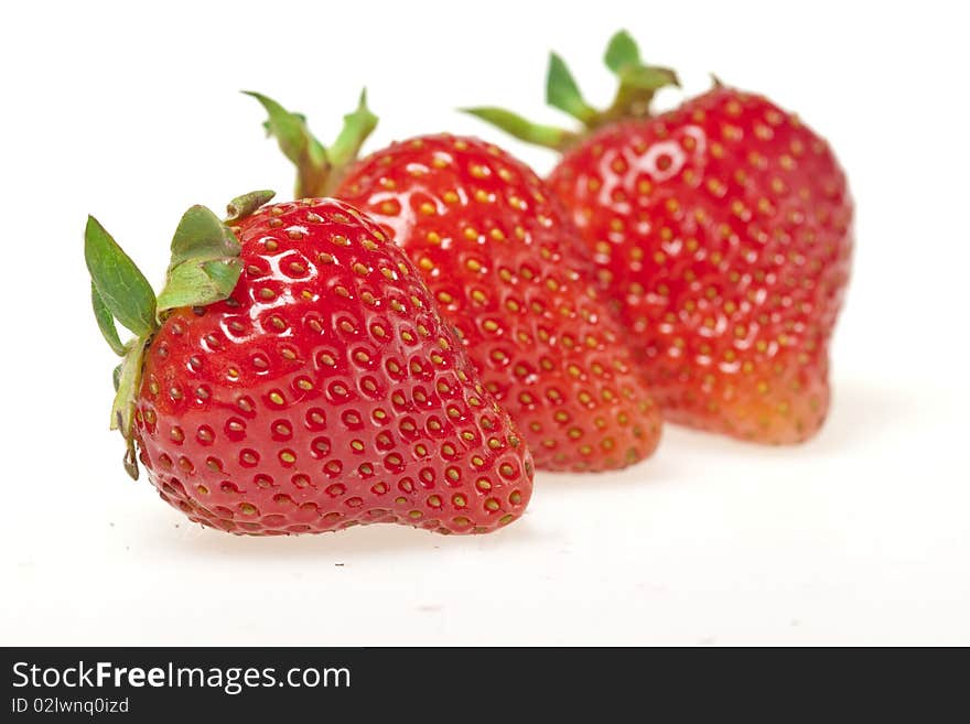 Juicy strawberries isolated on white background