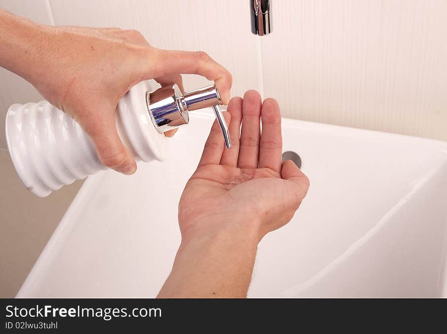 Squirting liquid soap into the palm of a hand. Squirting liquid soap into the palm of a hand