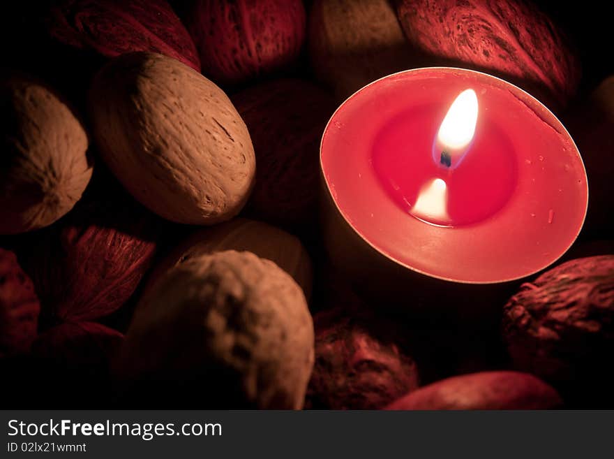 Candle burning in the dark, bright flame close up