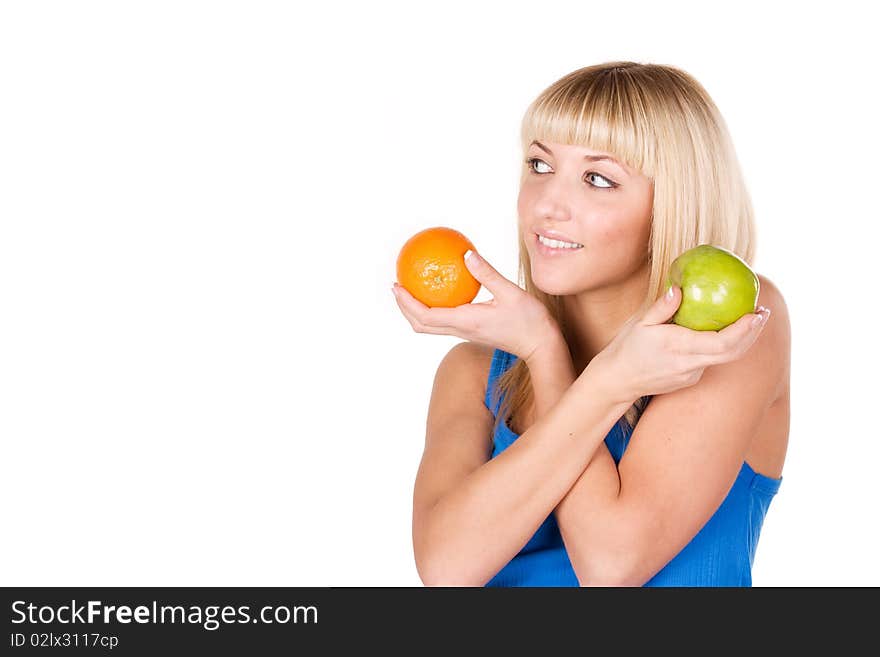 Beautiful girl chooses between orange and apple. Beautiful girl chooses between orange and apple