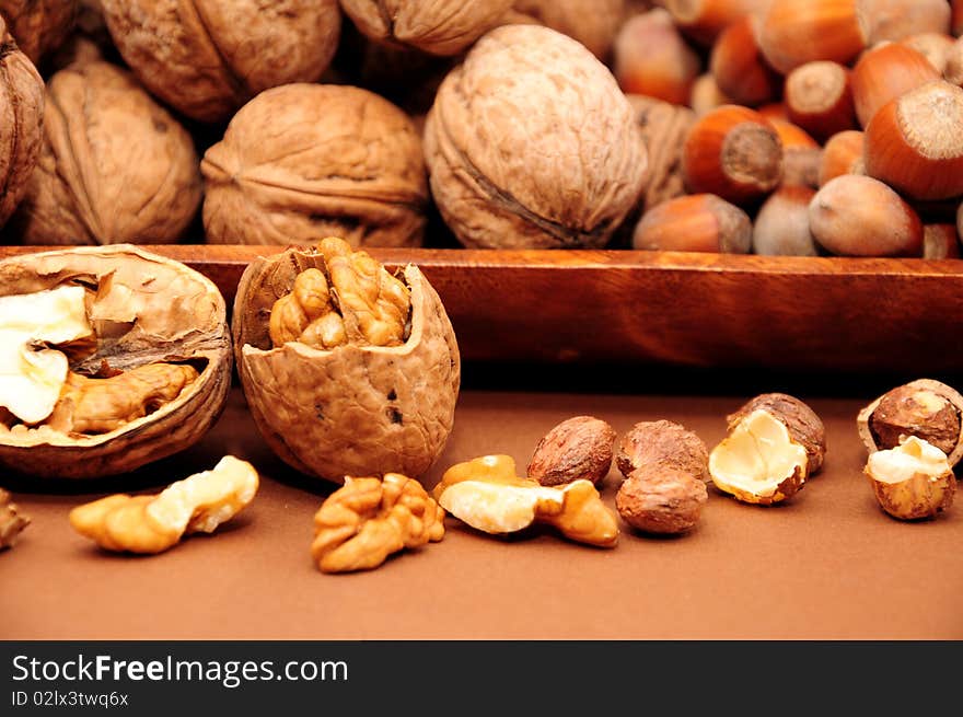 Walnuts and hazelnuts in a wooden bowl. Walnuts and hazelnuts in a wooden bowl