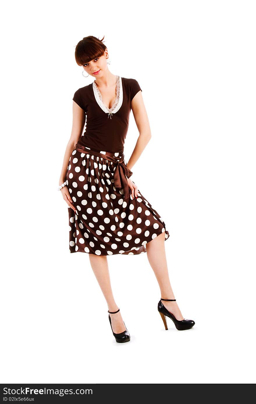 Picture of a beautiful alluring young girl in spotted skirt on white background