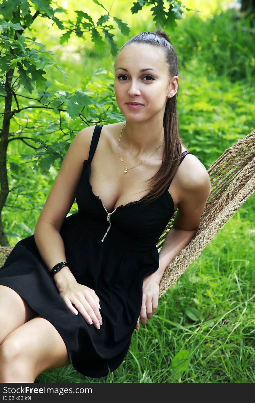 The young woman enjoys laying in a hammock. The young woman enjoys laying in a hammock